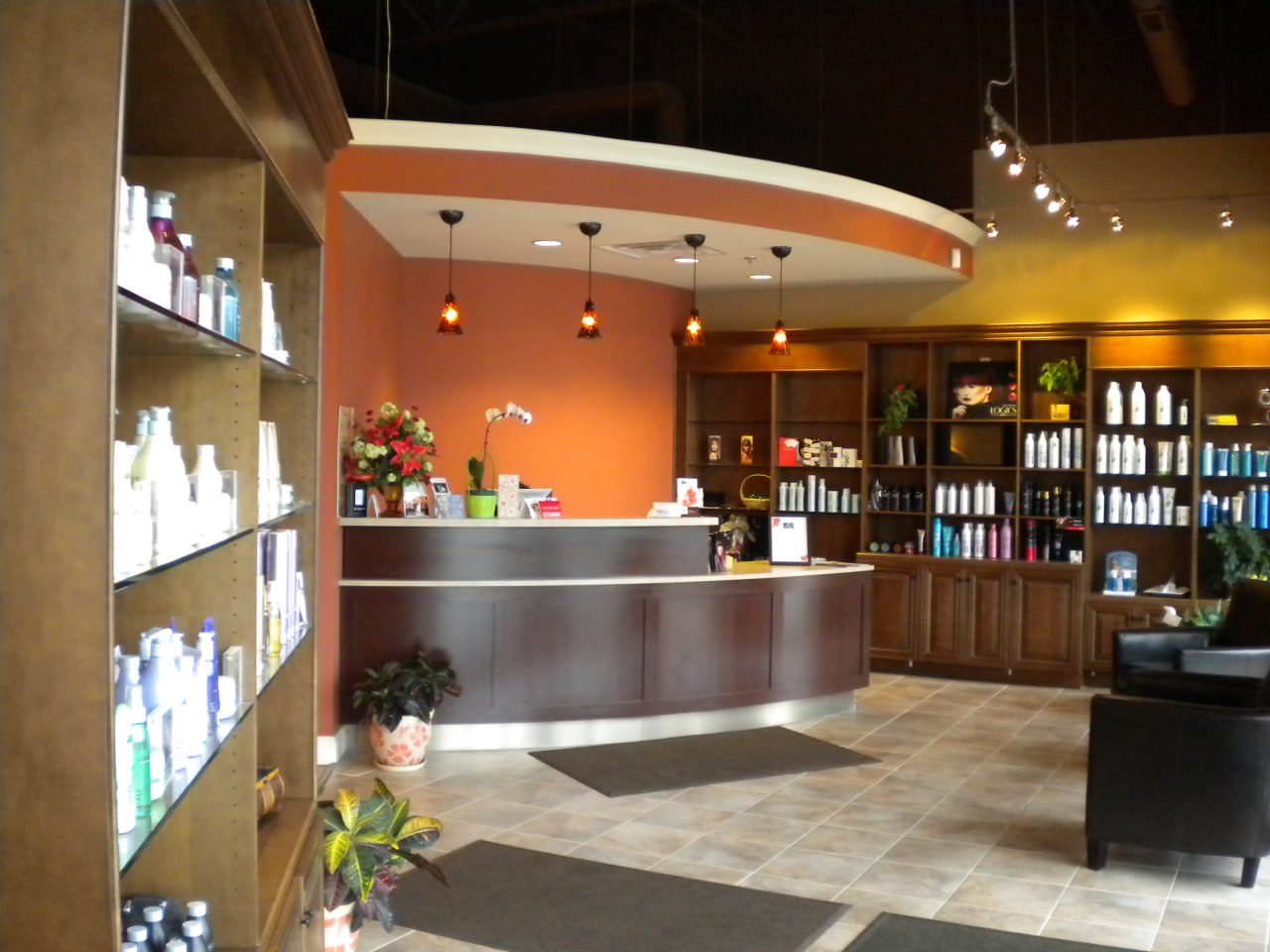 Hair salon interior with product shelving and reception desk