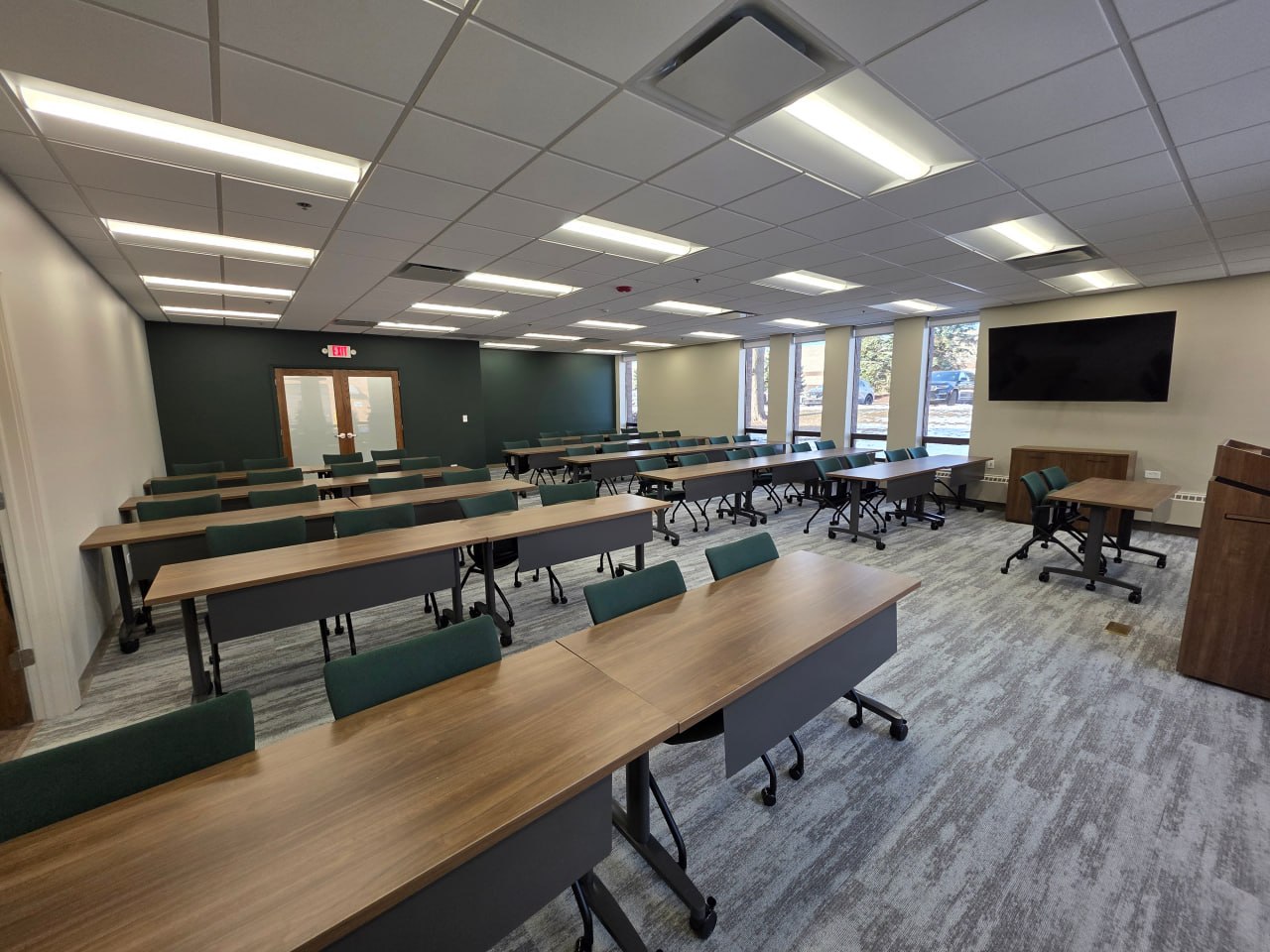 Conference room with U-shaped seating and mounted television
